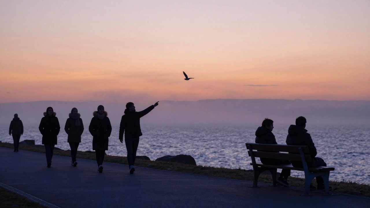 Два человека стоят на набережной на закате, молча смотрят на птицу в небе.